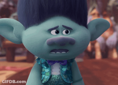 A Troll With Blue Hair And A Bow Tie GIF