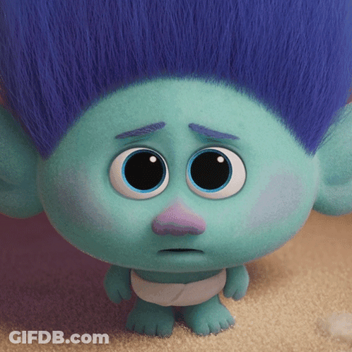 A Troll With Blue Hair And A Purple Nose Has A Sad Look On His Face GIF