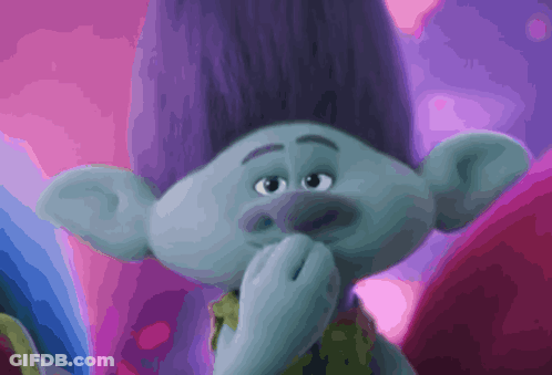 A Troll With Purple Hair Is Covering His Mouth GIF