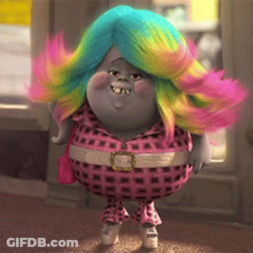 A Troll With Rainbow Hair Is Wearing A Pink Plaid Outfit GIF