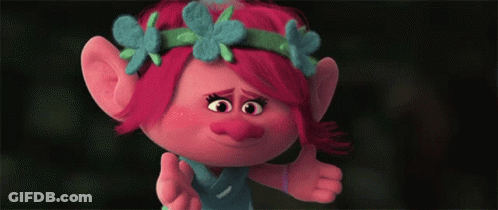 A Troll With Red Hair And Blue Flowers On Her Head Giving A Thumbs Up GIF