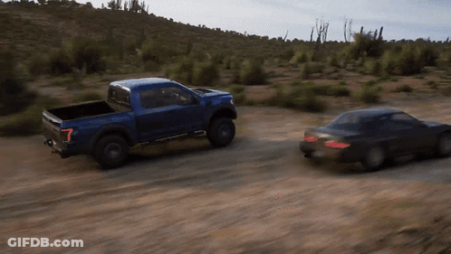 A Truck And A Car Are Driving Down A Dirt Road GIF