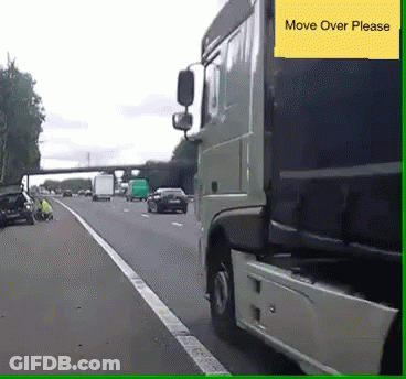 A Truck Is Driving Down A Highway And A Yellow Sign Says Move Over Please GIF