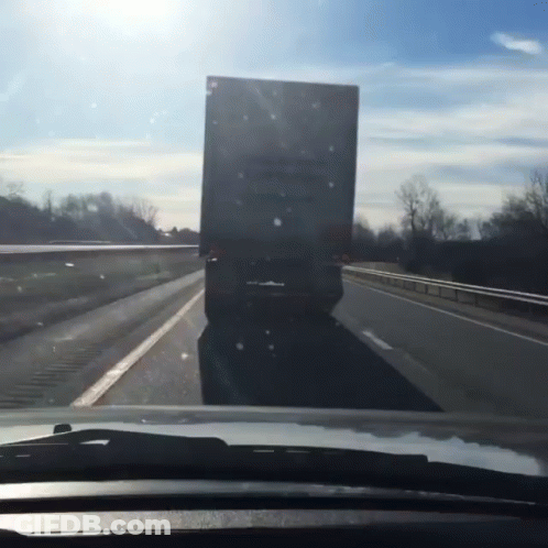 A Truck Is Driving Down A Highway With A Sign On The Back That Says ' A ' On It GIF