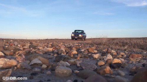 A Truck Is Driving Down A Rocky Road With A License Plate That Says ' Aa ' On It GIF