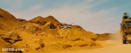 A Truck Is Driving Through A Desert Landscape GIF
