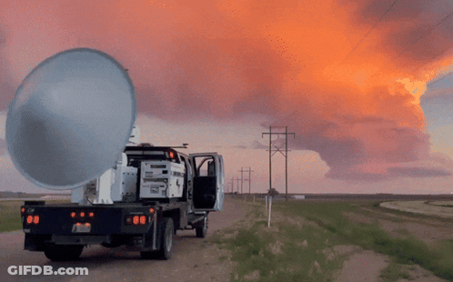 A Truck Is Parked On The Side Of A Dirt Road With A Sunset In The Background And The License Plate Says Nc GIF
