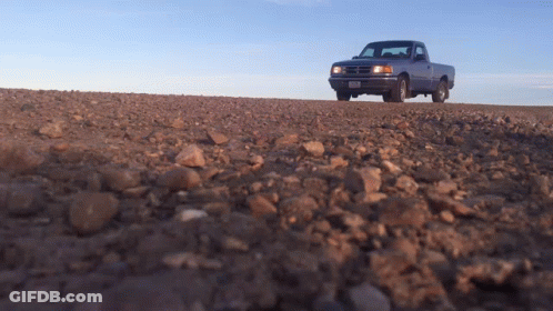 A Truck On A Dirt Road With A License Plate That Says ' Aa ' On It GIF
