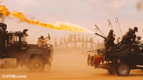 A Truck With A Flame Coming Out Of Its Exhaust Pipe Is Driving Through The Desert GIF
