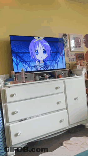 A Tv Screen Shows A Girl With Purple Hair And A Bow On Her Head GIF