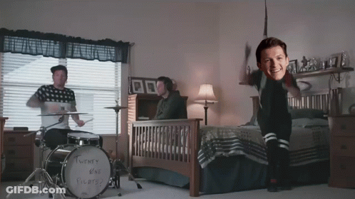 A Twenty One Pilots Drum Set Sits In A Bedroom Next To A Bed GIF