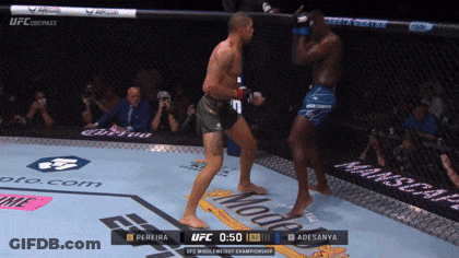A Ufc Fight Between Pereira And Adesanya Is Being Shown On A Screen GIF