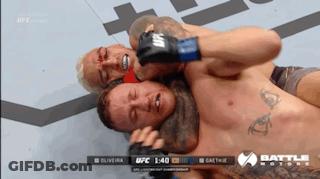 A Ufc Fight Is Being Shown On A Television GIF