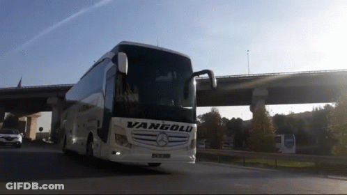 A Vanyolu Bus Is Driving Down A Highway Under A Bridge GIF