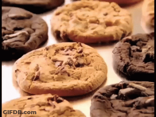 A Variety Of Cookies Are On A Table Including Peanut Butter And Chocolate Chip Cookies GIF