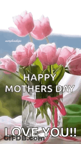 A Vase Filled With Pink Flowers Is Sitting On A Table . GIF