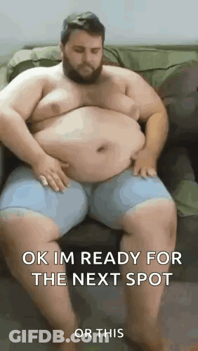 A Very Fat Man Is Sitting On A Couch . GIF