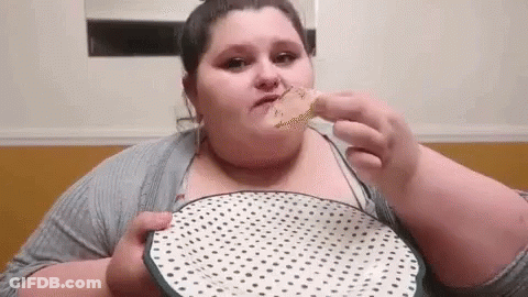 A Very Fat Woman Is Eating A Piece Of Food From A Polka Dot Plate . GIF