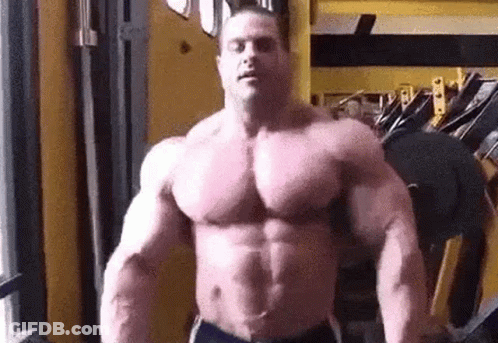 Large Muscular Man Standing With Arms Outstretched GIF