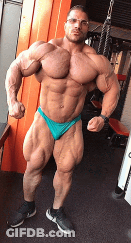 Muscular Man With Glasses In Green Underwear Posing In Gym GIF