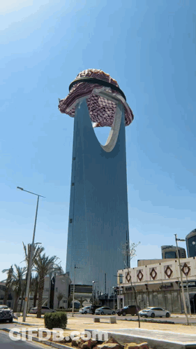 A Very Tall Building With A Scarf On Top GIF