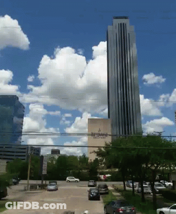 A Very Tall Building With A Sign That Says Ritz - Carlton On It GIF