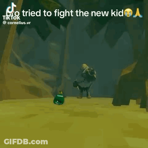 A Video Game Character Is Laying On The Ground In Front Of A Rock . GIF