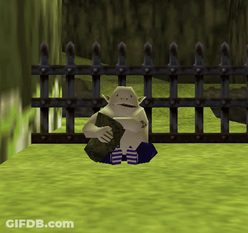 A Video Game Character Is Sitting In Front Of A Fence Holding A Rock GIF