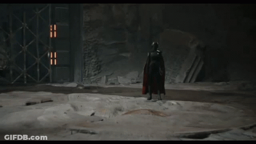 A Video Game Character Is Standing In A Dark Room And Talking To Col Kesis GIF