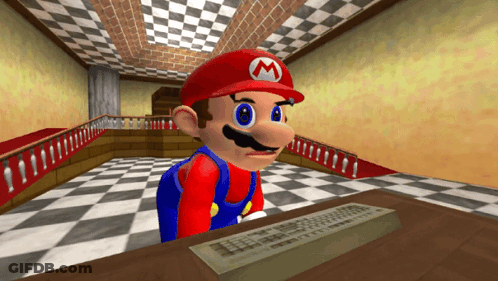 A Video Game Character Named Mario Is Sitting At A Desk GIF