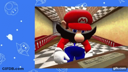 A Video Game Character Named Mario Is Sitting At A Desk With A Keyboard GIF