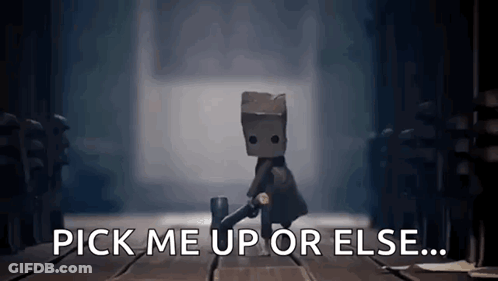 A Video Game Character With A Bag On His Head Is Standing On A Wooden Floor And Says `` Pick Me Up Or Else ... '' GIF