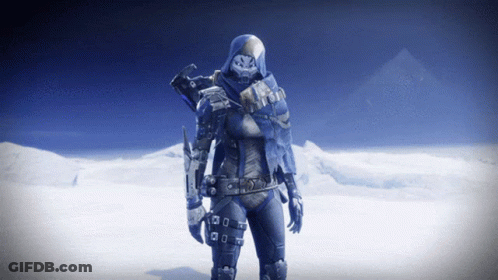 A Video Game Character With A Hood On Stands In Front Of Snowy Mountains GIF