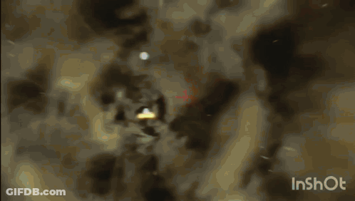A Video Of A Light Coming Out Of A Hole In The Ground GIF