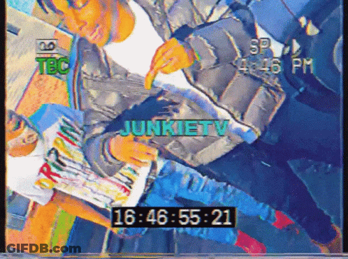 A Video Of A Man Reading A Magazine Says Junkietv At The Top GIF