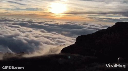 A Video Of A Mountain Covered In Clouds With The Words Viralhog On The Bottom Right GIF
