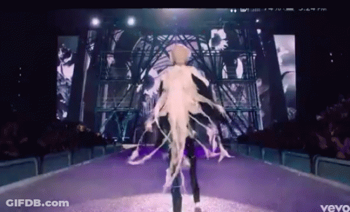A Video Of A Woman Walking Down A Runway With The Word Vevo At The Bottom GIF