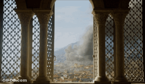A View Of A City From A Balcony With Columns GIF