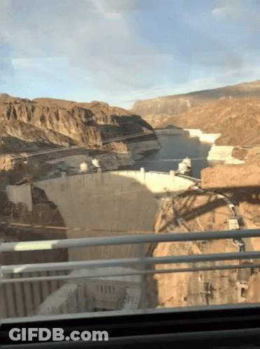 A View Of A Large Body Of Water From A Bridge GIF