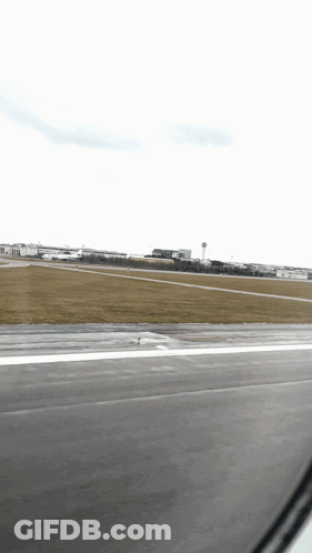 A View Of An Airport Runway From An Airplane GIF