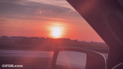 A View Of The Sunset From Inside A Car GIF