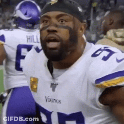 A Vikings Football Player With A Beard Is Wearing A White And Purple Uniform . GIF