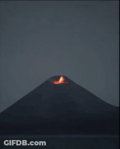 A Volcano Is Erupting With A Lot Of Smoke Coming Out Of It GIF