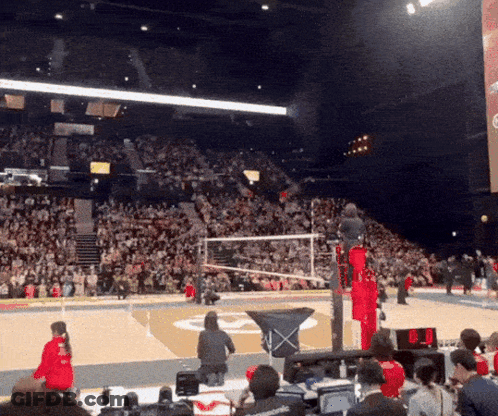 A Volleyball Game Is Being Played In A Stadium With A Large Crowd GIF