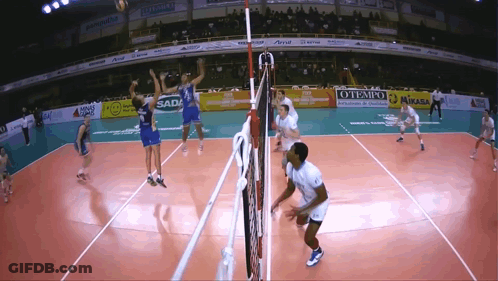 A Volleyball Game Is Being Played In A Stadium With Ads For Mikasa GIF