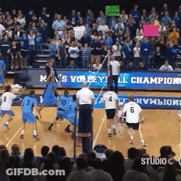 A Volleyball Game Is Being Played In Front Of A Crowd With A Sign That Says M 'S Volleyball Champion GIF