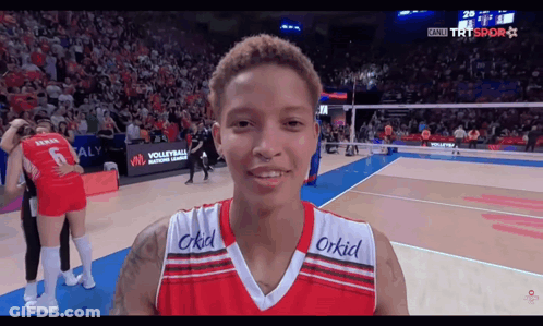 A Volleyball Player Wearing A Red And White Jersey With The Word Orkid On The Front GIF