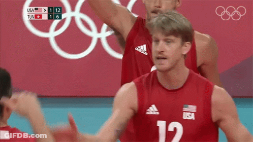 A Volleyball Player Wearing A Red Jersey With The Number 12 On It GIF