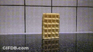 A Waffle Bar Is Sitting On A Counter In Front Of A Tiled Wall .. GIF