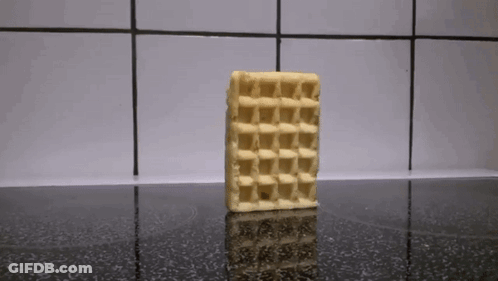 A Waffle Sitting On Top Of A Black Counter GIF